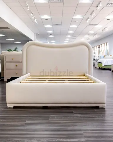 King size Upholstered Platform  featuring a distinctive curved, cloud-like headboard