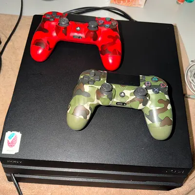 Sony PlayStation 4 Pro with two camo DualShock 4 controllers (works fine)