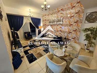 For rent in Sharjah, Al Mamzar, Palm Tower 1: One bedroom, living room, and balcony with a view. Rent is 5000 AED with internet only.deposit 1000