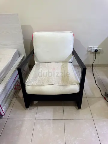 Modern wooden frame lounge chair with white cushions