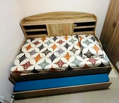 Wooden single bed with storage headboard and pull-out trundle mattress