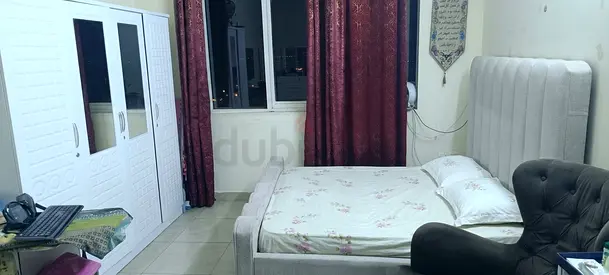Light grey upholstered double bed with headboard and mattress