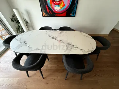 Modern oval marble-like-top dining table with 6 upholstered chairs. Good condition.