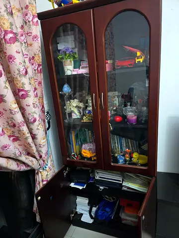 Wooden display cabinet with glass doors and storage compartments