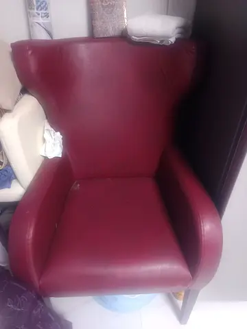 Maroon leather armchair with high back, and small dining table gently used