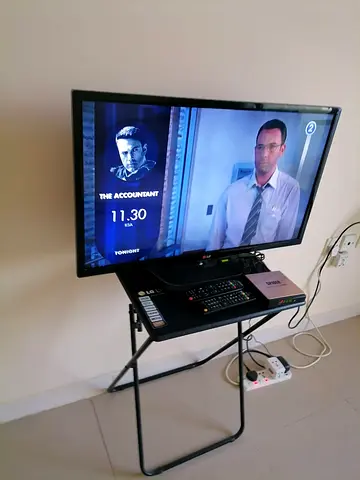 TV Not Smart Basic with Table underneath 200 AED Price Is Not Negotiatable No Bargein Pick Up Sharj