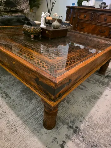 Wooden coffee table with glass top