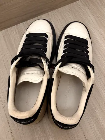 Alexander McQueen white leather sneakers with black trim - gently used