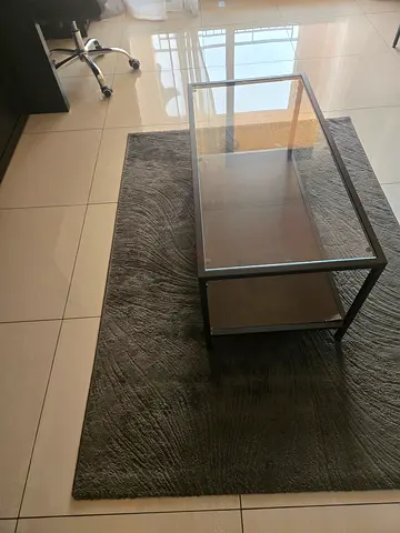 Dark grey textured area rug with glass-top coffee table (set)