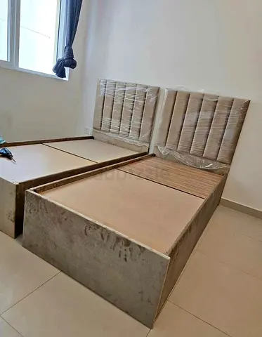 Two single beds with upholstered headboards — good condition