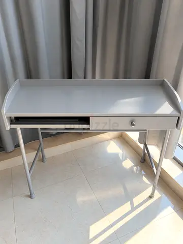 Compact gray writing desk with drawer and keyboard tray