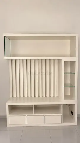 White modern entertainment center with shelves and drawers, TV unit