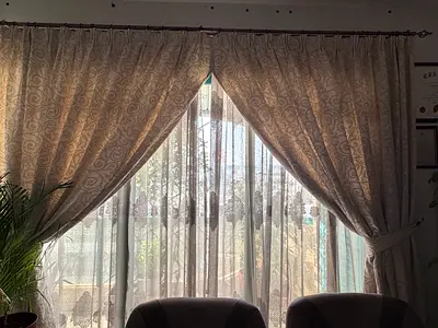 Pair of beige patterned curtains with sheer liners, used, good condition