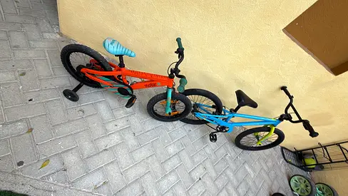 Two kids bicycles with training wheels - blue and orange 230 both