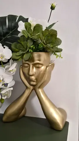 Gold face planter/decoration with faux floral arrangement