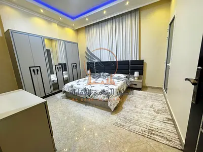 For monthly rent in Ajman: a furnished apartment with three rooms and a living area, featuring high