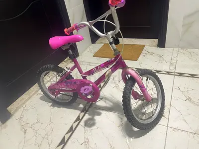 Pink kids' 12-inch bicycle with training wheels — good condition