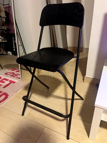 Black metal folding chair with wood-look seat and back - good condition