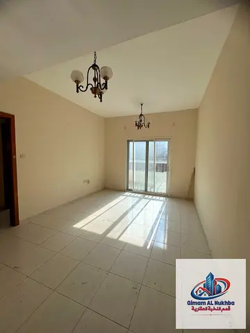 Discover a spacious one-bedroom apartment in Al Mujarrah, Sharjah, featuring an open-view balcony,