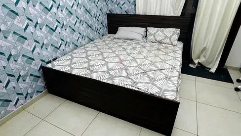 Dark wood double bed frame with headboard — good condition