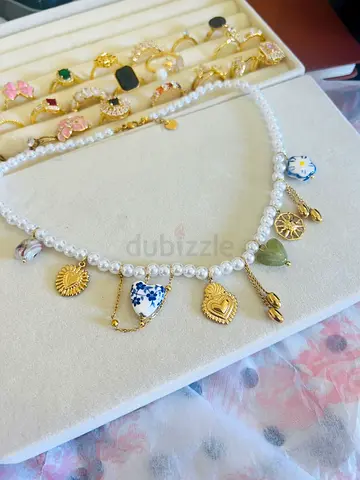 Handmade pearl charm necklace with mixed gold-tone pendants