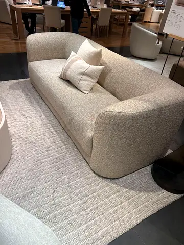 Three-seater beige boucle sofa