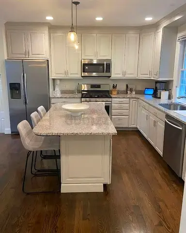 Modern white kitchen  island and round marble top same as kitchen
