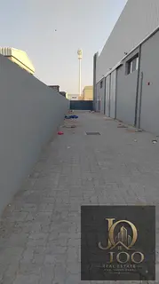 Industrial Warehouse for Rent in Umm Al Dera – Enclosed Warehouse with External Storage Yard, High