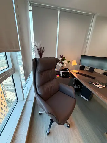 Comfortable brown leather office desk chair with wheels