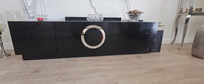 Black modern low TV cabinet with circular chrome handle