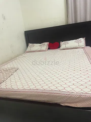 King size bed frame with mattress and bedding - dark wood headboard