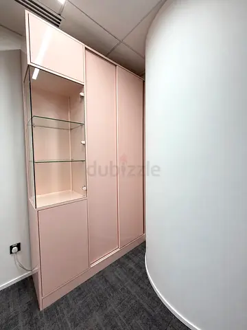 Pink built-in wardrobe with glass display cabinet