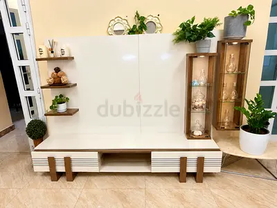 White lacquer TV unit with wood accents and display shelves