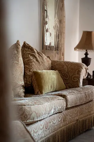 Comfortable patterned 2-seater sofa with 2 side chairs and pouf