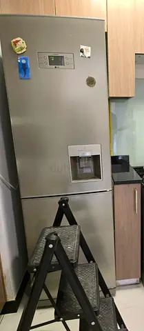 Silver bottom-freezer refrigerator with water dispenser - good working condition