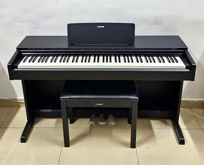 The Yamaha Arius YDP-105B is an 88-key entry-level console digital piano featuring a Graded Hammer