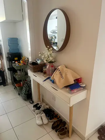 White hallway console table with drawers and wooden legs - good condition , mirror included .