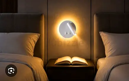 Modern wall-mounted bedside reading lamp with warm LED halo