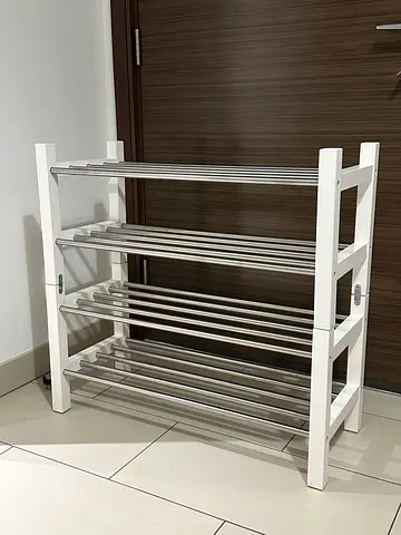 White wooden multi-tier shoe rack with metal rails - good condition