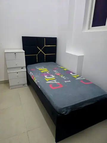 Single bed frame with mattress and bedside drawer unit and wardrobe
