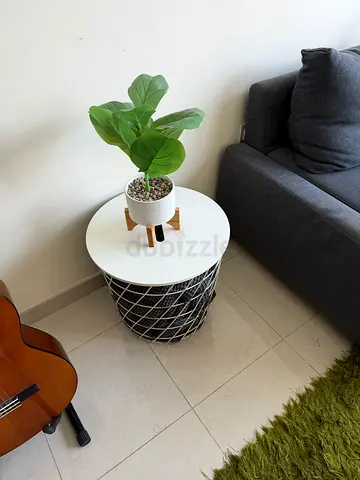 Round white side table with wire basket base