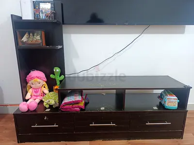 Dark wood TV unit with storage drawers and open shelves