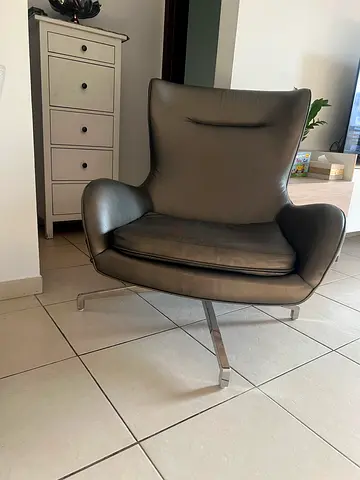 Modern grey leather lounge chair with chrome legs