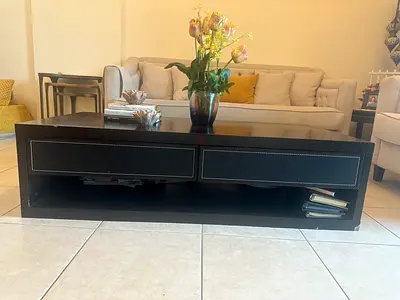 Low modern black coffee table and two side tables with storage drawers