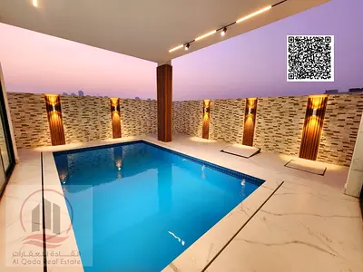 Villa for sale in Al Helio 2, Ajman, including registration fees. The villa has a swimming pool (5 master bedrooms,a large living room, a laundry room