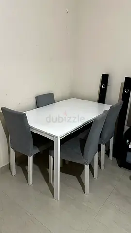 White dining table with 4 grey upholstered chairs - compact set