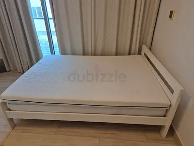 White wooden double bed frame with mattress - good condition.