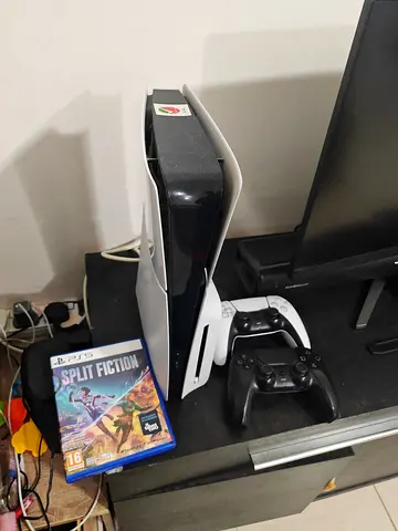 PlayStation 5 console with DualSense controllers and 1 game (Split Fiction)