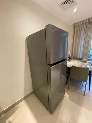 LG two-door refrigerator in excellent condition- glass shelves- quiet inverter motor