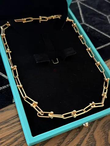 Gold-tone link necklace with floral bead accents